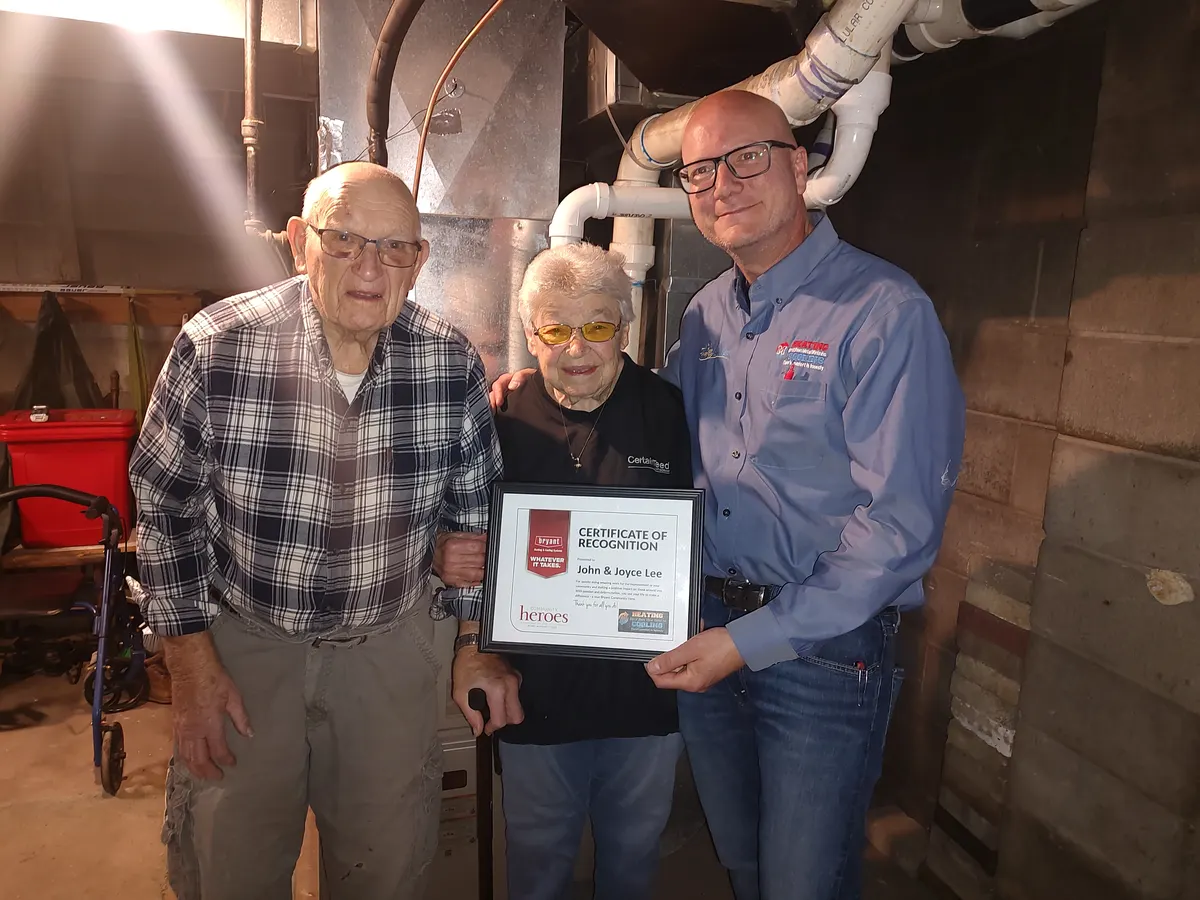 Kurt Wendt with John and Joyce Lee of Merrill and their 2026 Bryant Community Heroes Award certificate