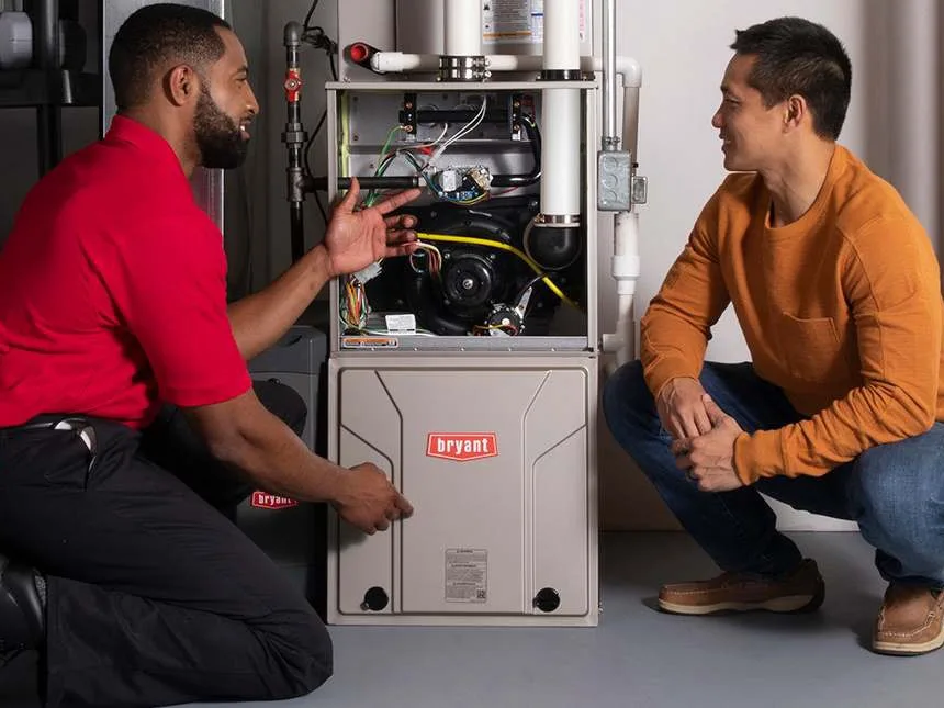 A Bryant dealer explains what the inspection found, right at the open furnace