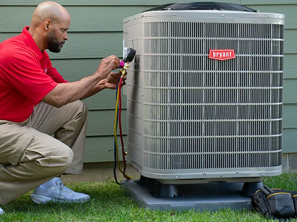 A Bryant technician checks the charge on a heat pump