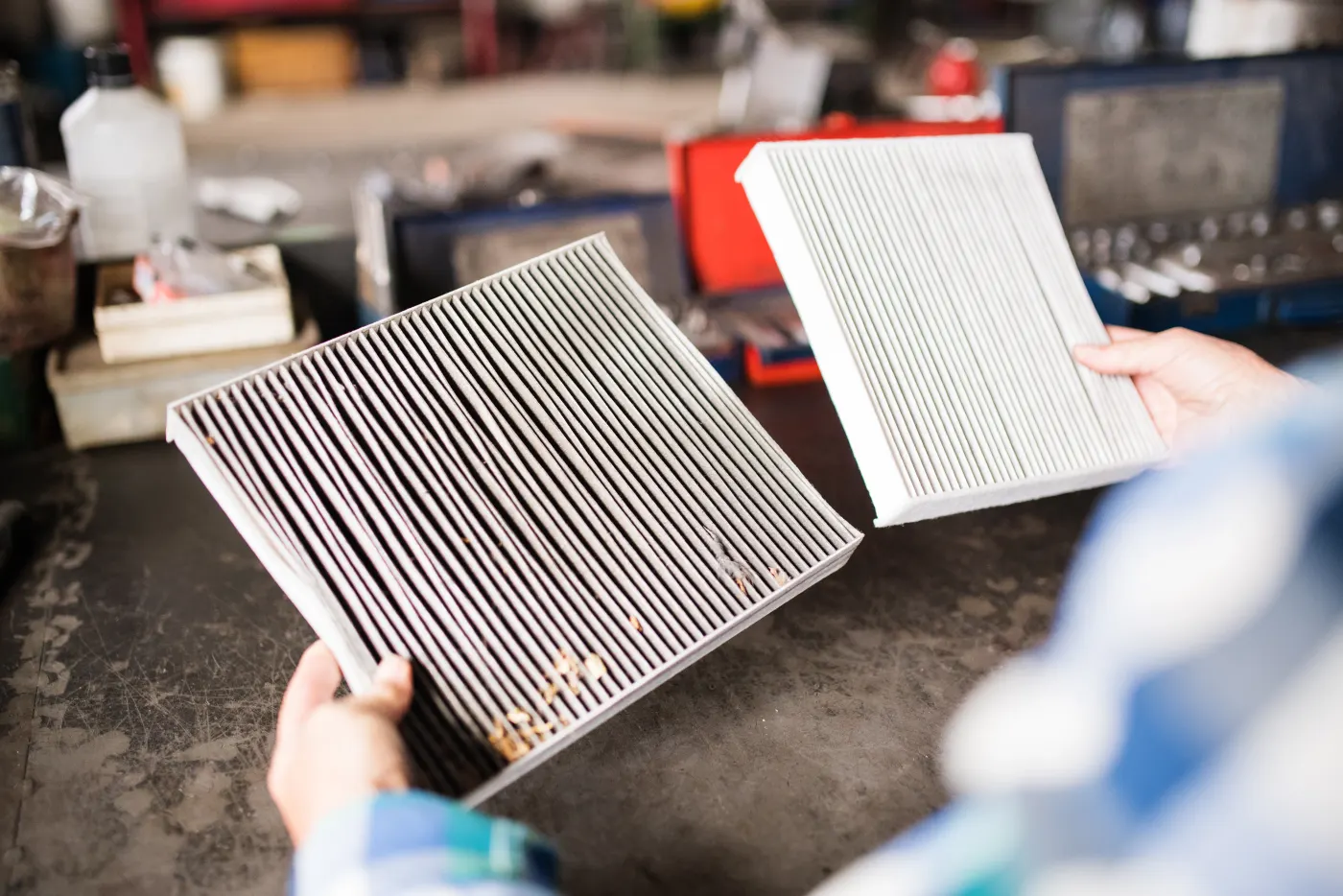 A clogged air filter held next to a clean one — the story most air complaints tell